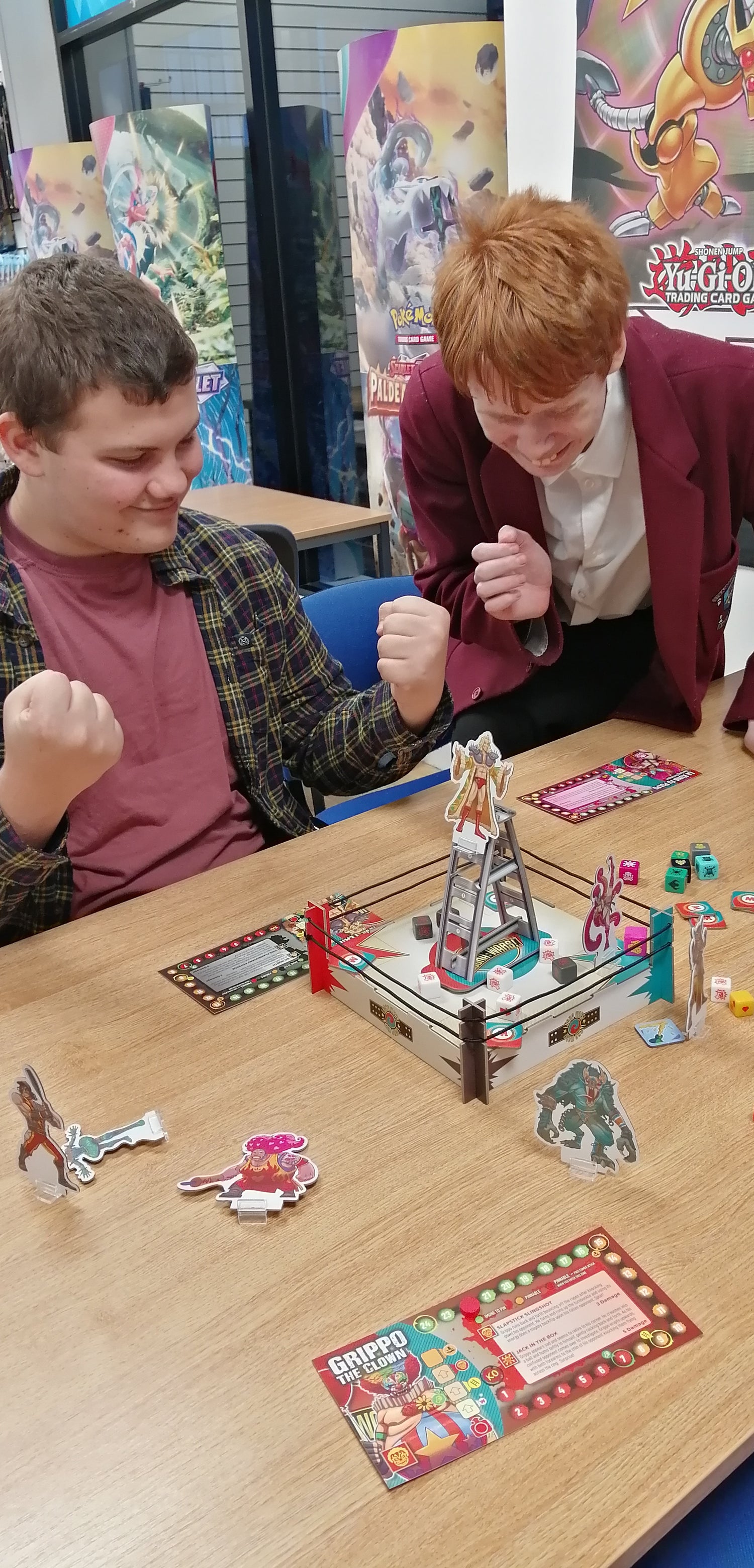 A happy group of young adults playing a family tabletop board game from Backspindle Games, celebrating 15 years of publishing indie board games and strategic card games.